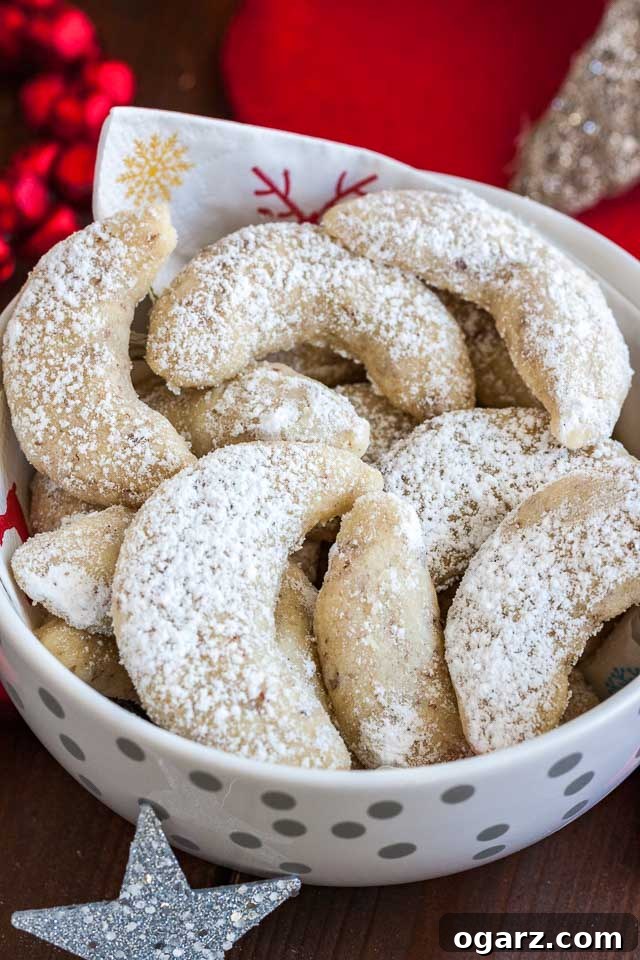 Melt-in-Your-Mouth German Vanilla Crescents 6 Close-up of a white bowl with a napkin, of Vanillekipferl cookies.