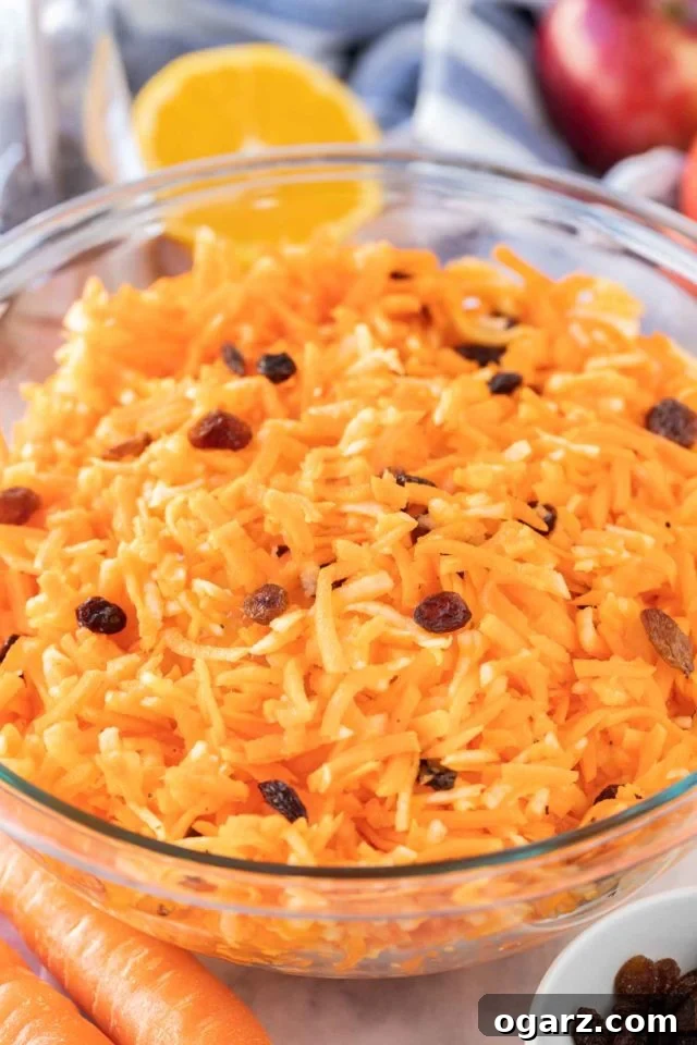 Carrot salad with raisins in a glass bowl