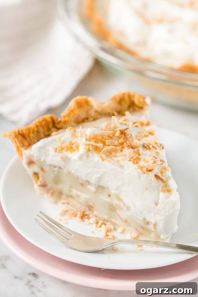 Heavenly Coconut Bliss 2 A slice of Coconut Cream Pie on a plate with a fork
