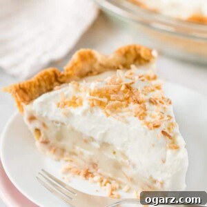 Heavenly Coconut Bliss 8 A slice of Coconut Cream Pie on a plate with a fork