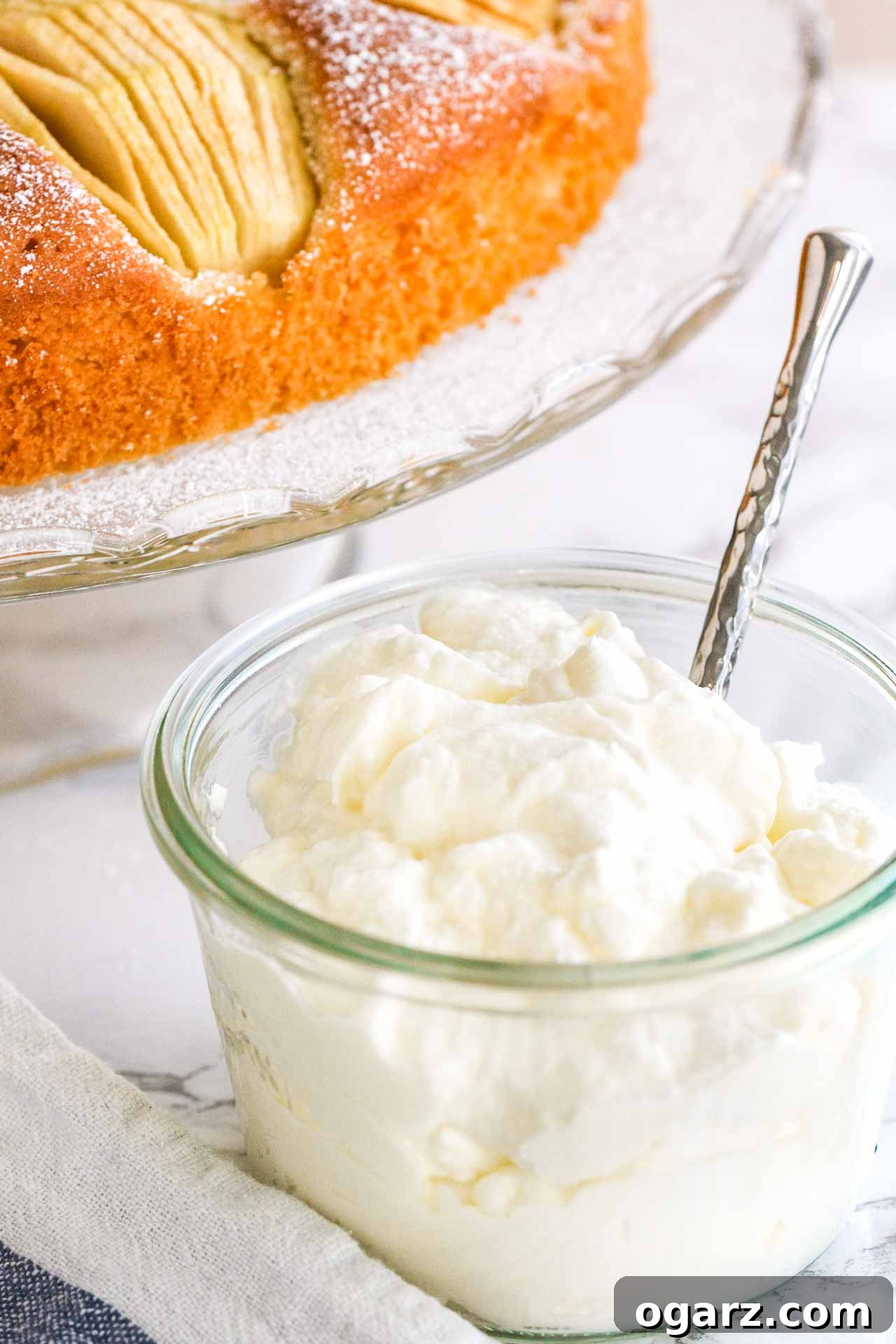 Silken Whipped Delight 6 Freshly made whipped cream in a rustic glass jar with a spoon, ready to be enjoyed.
