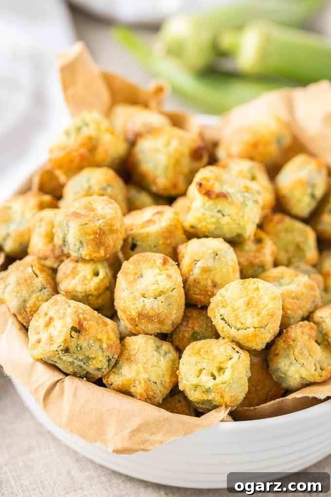 Crispy Air Fryer Okra 5 A bowl filled with Air Fryer Okra, perfectly golden and crispy, garnished with a sprinkle of fresh herbs.