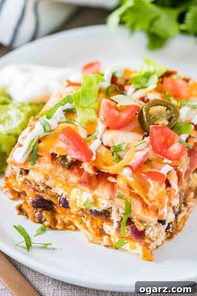 Fiesta Lasagna 3 A piece of Taco Lasagna with guacamole and sour cream