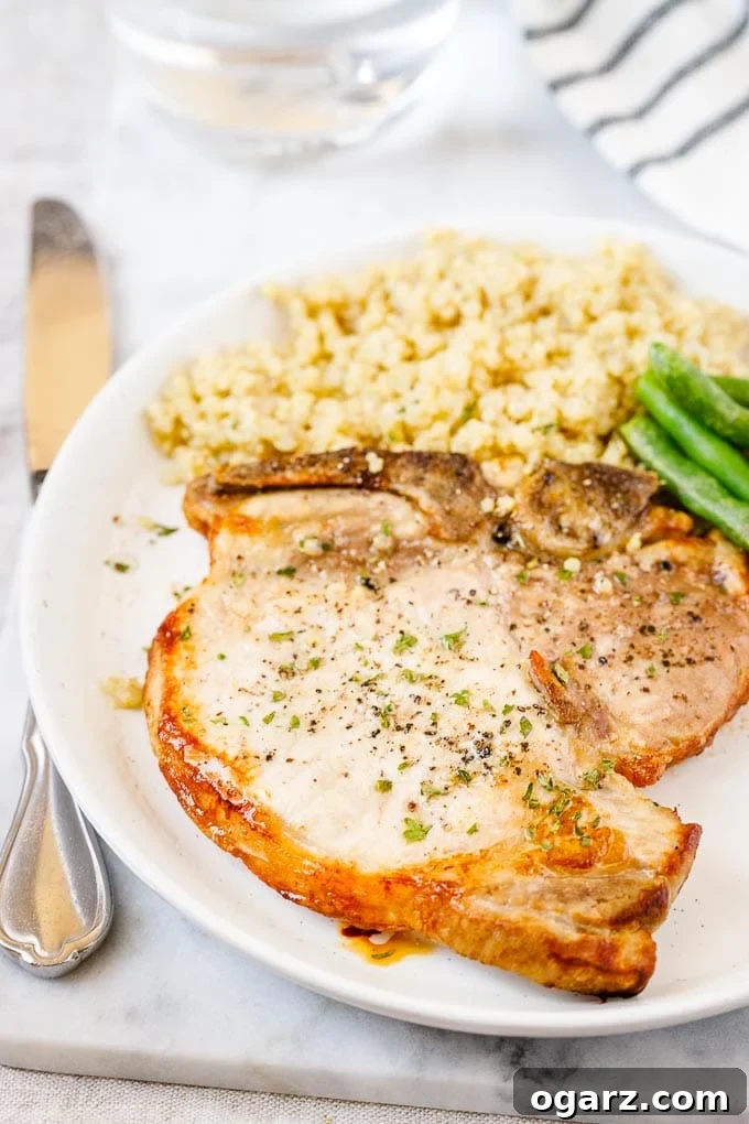 Perfect Air Fryer Pork Chops 2 A plate with Air Fryer Pork Chops, Quinoa and Green beans.