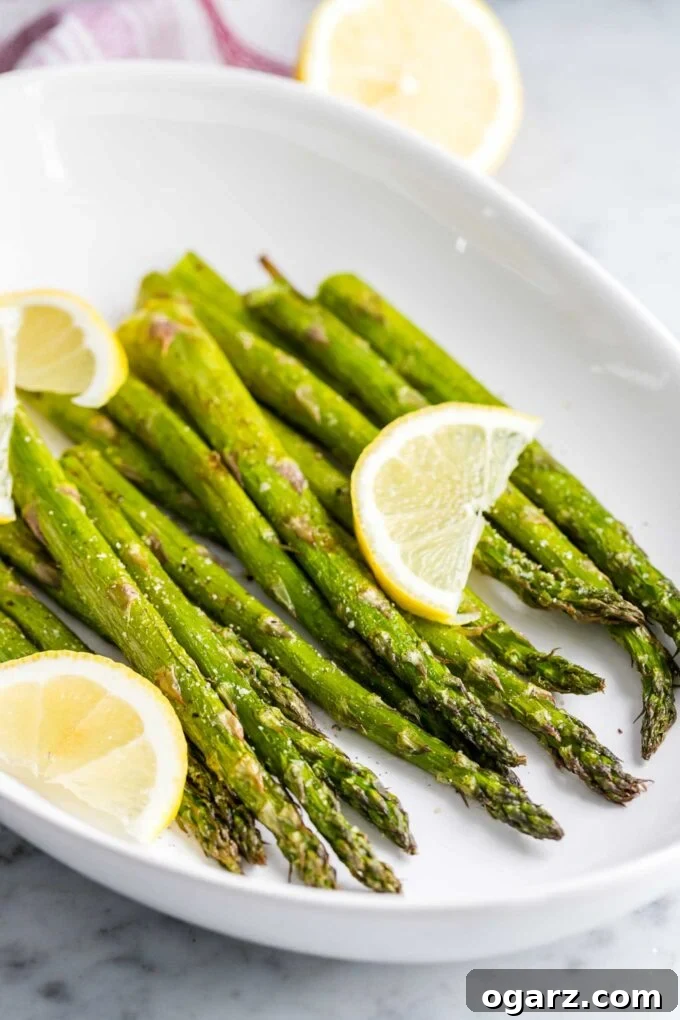 Crispy Air Fryer Asparagus 2 Roasted Asparagus on a plate with lemon slices