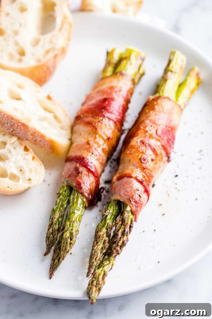 Crispy Air Fryer Asparagus 4 Asparagus wrapped in bacon on a plate