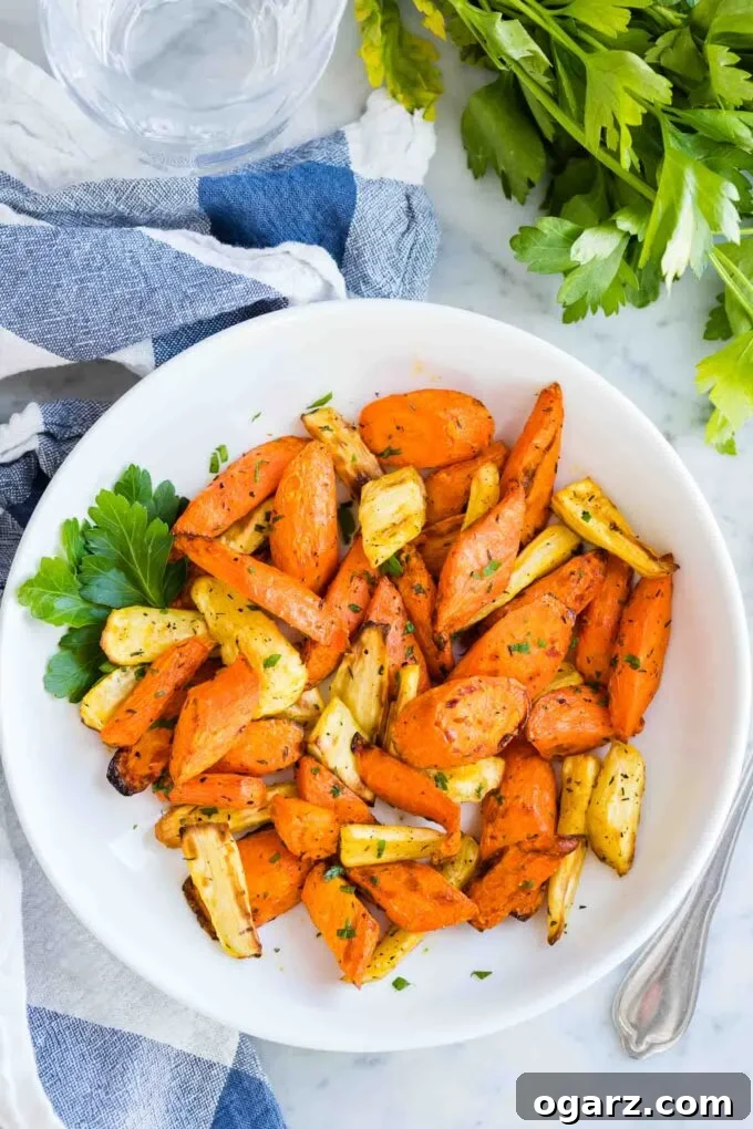 Crispy Air Fryer Carrots 5 Roasted Carrots on a plate sprinkled with fresh parsley