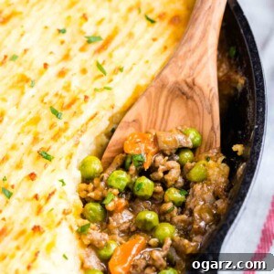 Shepherd's Pie in a pan with a wooden spoon in it