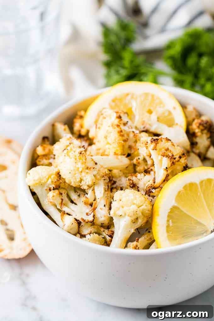 Perfectly Crispy Air Fryer Cauliflower 2 Crispy Air Fryer Cauliflower in a bowl, garnished with fresh herbs.