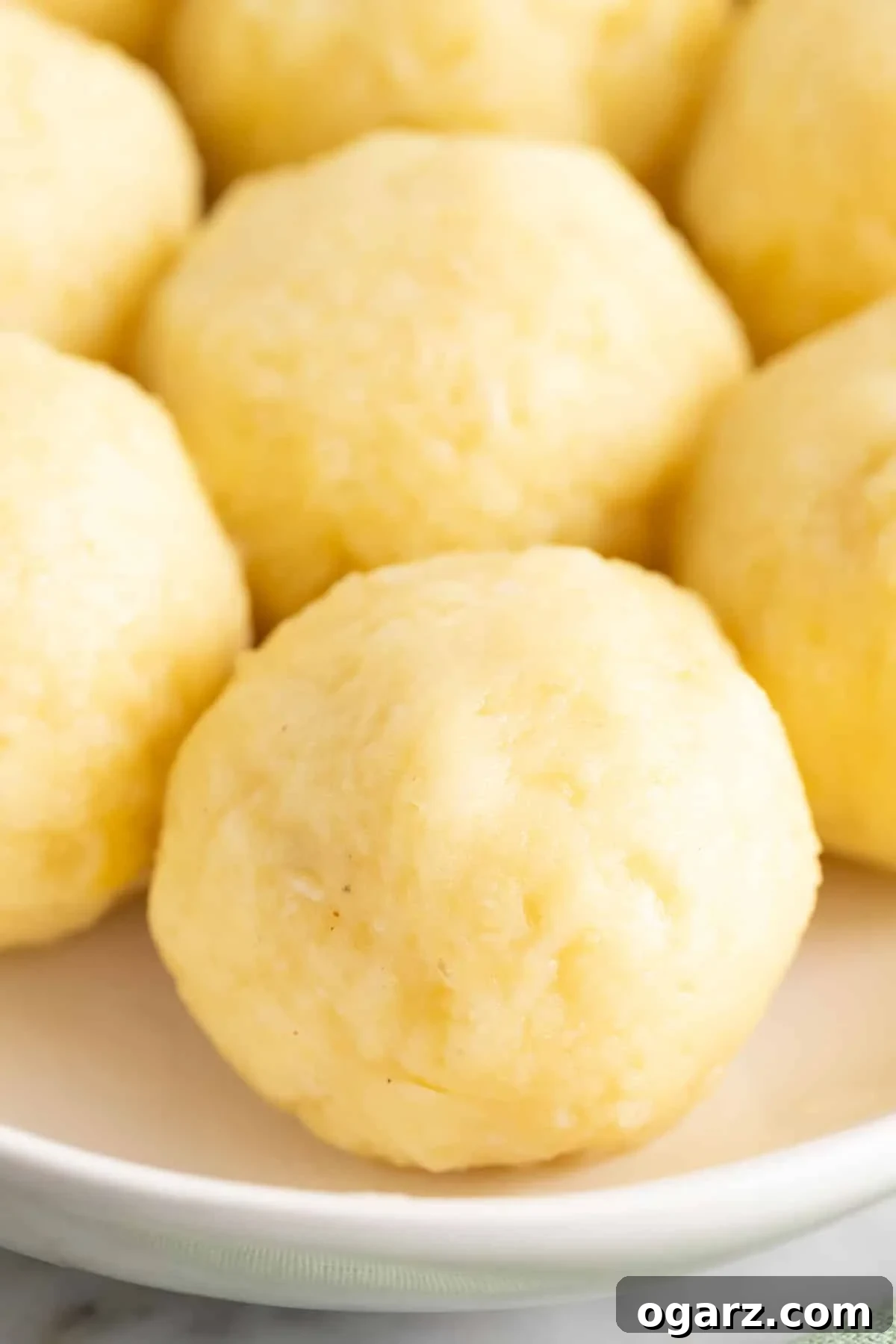 Pillowy Potato Bites 2 A beautifully plated dish of Kartoffelkloesse, showcasing their soft, round form and inviting texture, ready to be enjoyed.