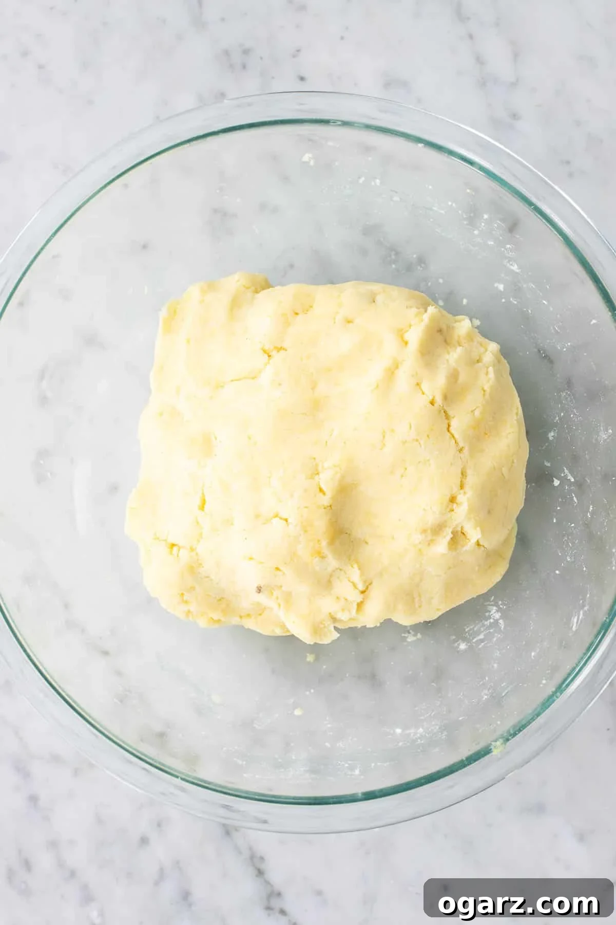 Pillowy Potato Bites 9 Hands gently kneading the dough for Kartoffelknoedel until it forms a cohesive, smooth mass, being careful not to overmix.