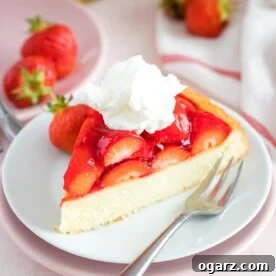 A slice of strawberry cake on a plate with a fork