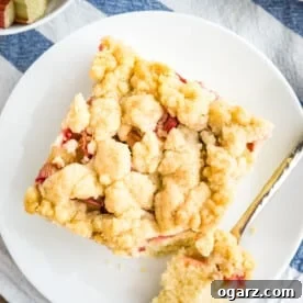 A slice of rhubarb streusel cake on a plate.