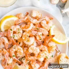 Shrimp on a plate with lemon slices and bread