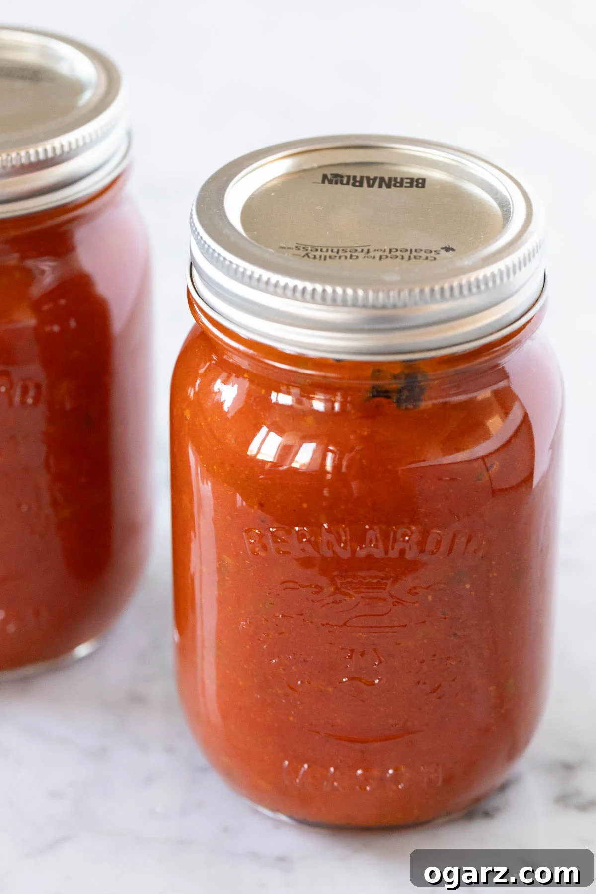 Jars of homemade currywurst sauce for easy meal prep and freezing.