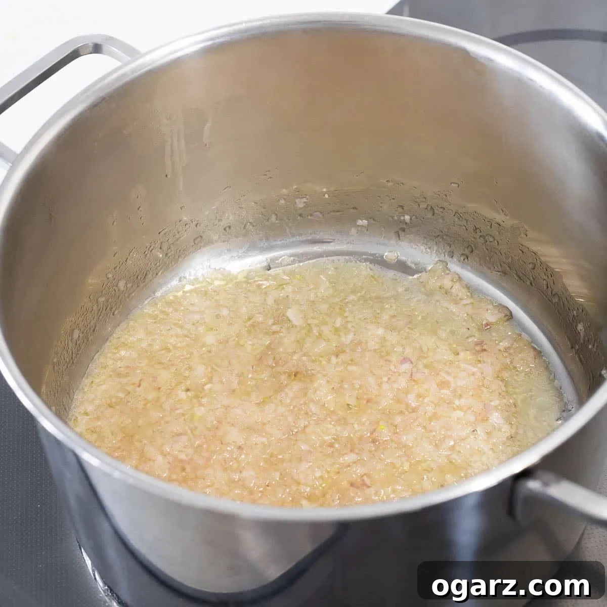 Onions cooking in a saucepan.