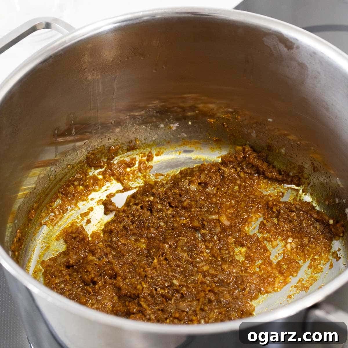 Onions and curry powder in a pot.