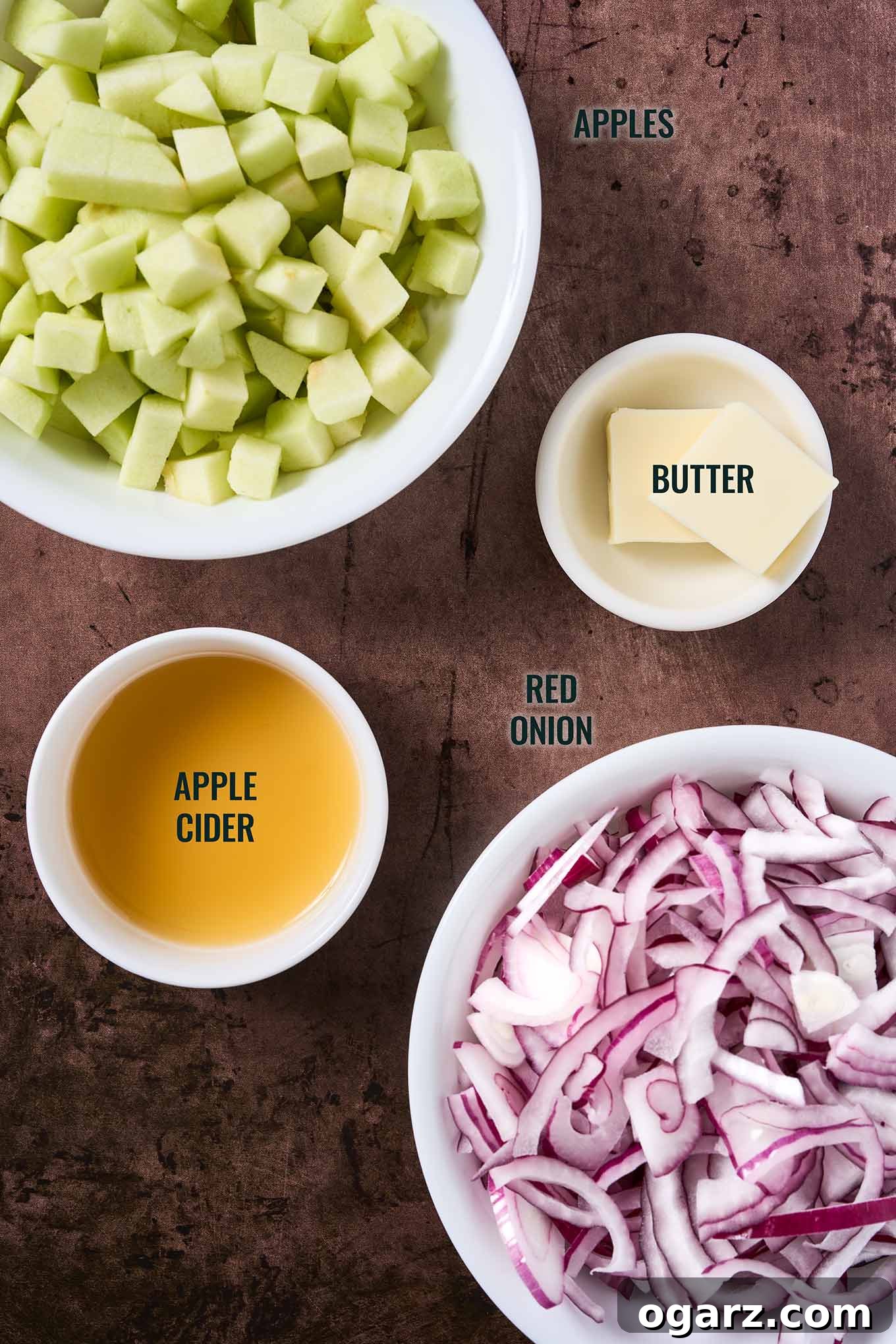 Caramelized Apples and Onions for Roasts and Salads 3 Ingredients for caramelized apples and onions; diced apples, sliced red onion, butter, and apple cider arranged in white bowls.